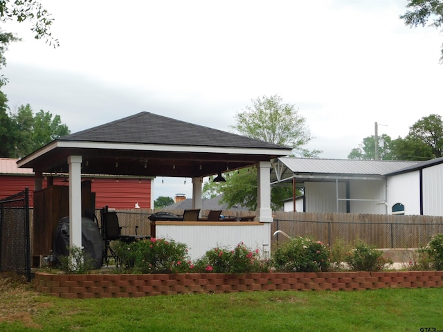 exterior space with fence and a gazebo