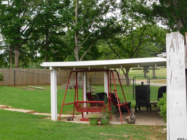 view of jungle gym featuring fence and a lawn