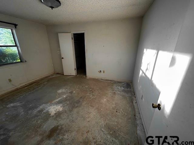 unfurnished bedroom with a textured ceiling