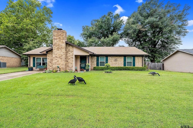 ranch-style home featuring central AC unit and a front lawn