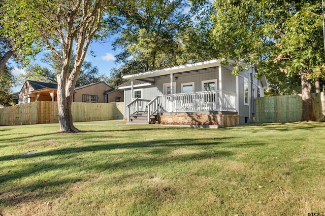 view of front of home featuring a front yard and a porch