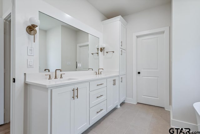 7130 Alexander Dr, Tyler, TX 75707 - bathroom with double vanity, tile patterned flooring, and a freestanding bath