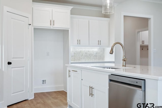 7130 Alexander Dr, Tyler, TX 75707 - kitchen with stainless steel dishwasher, light countertops, white cabinetry, decorative backsplash, and light wood finished floors