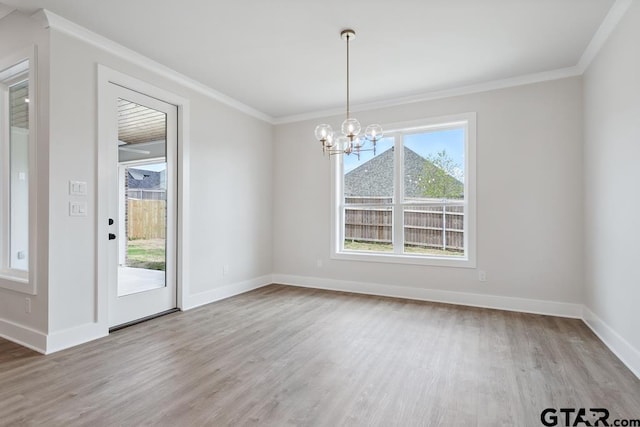 7130 Alexander Dr, Tyler, TX 75707 - unfurnished dining area featuring wood finished floors, a chandelier, and ornamental molding