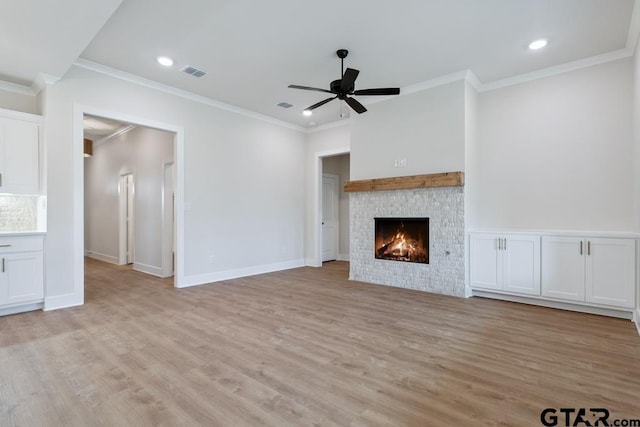 7130 Alexander Dr, Tyler, TX 75707 - unfurnished living room featuring light wood-style flooring, ornamental molding, a ceiling fan, a stone fireplace, and recessed lighting
