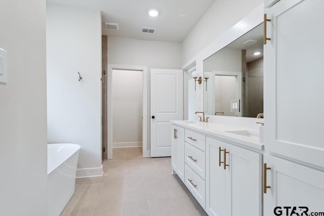 7130 Alexander Dr, Tyler, TX 75707 - full bathroom with double vanity, a freestanding tub, a stall shower, tile patterned floors, and recessed lighting