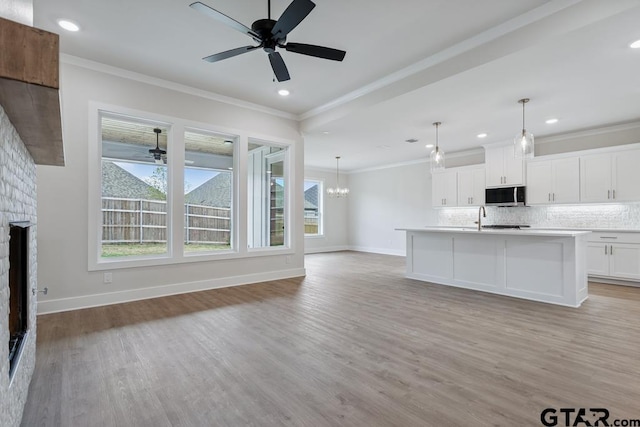7130 Alexander Dr, Tyler, TX 75707 - unfurnished living room with ceiling fan, a brick fireplace, plenty of natural light, light wood finished floors, and recessed lighting