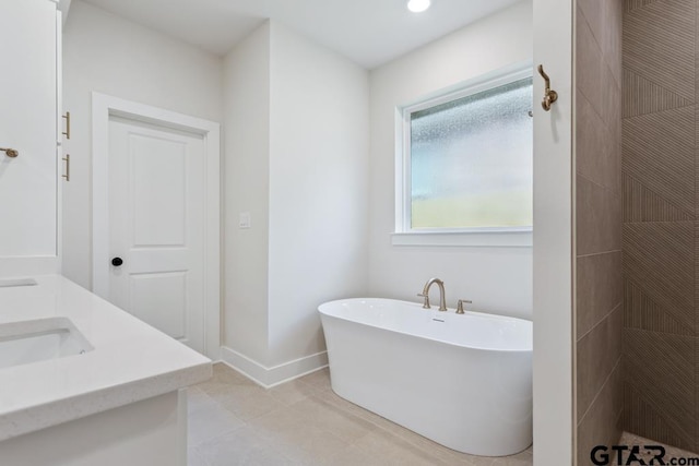 7130 Alexander Dr, Tyler, TX 75707 - full bathroom featuring a freestanding tub, double vanity, a tile shower, and tile patterned floors