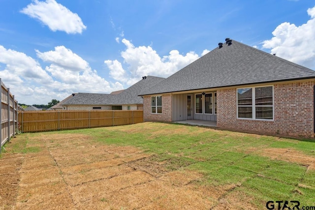 7130 Alexander Dr, Tyler, TX 75707 - rear view of property featuring brick siding, roof with shingles, a fenced backyard, and a patio