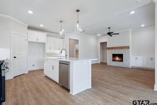 7130 Alexander Dr, Tyler, TX 75707 - kitchen with dishwasher, ornamental molding, ceiling fan, white cabinetry, and light countertops