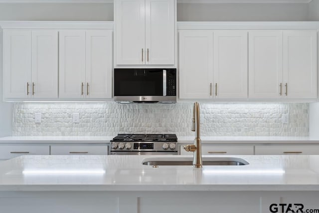 7130 Alexander Dr, Tyler, TX 75707 - kitchen with stainless steel appliances, white cabinets, tasteful backsplash, and light stone countertops