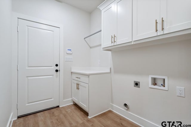 7130 Alexander Dr, Tyler, TX 75707 - washroom with light wood-type flooring, hookup for a washing machine, cabinet space, and hookup for an electric dryer