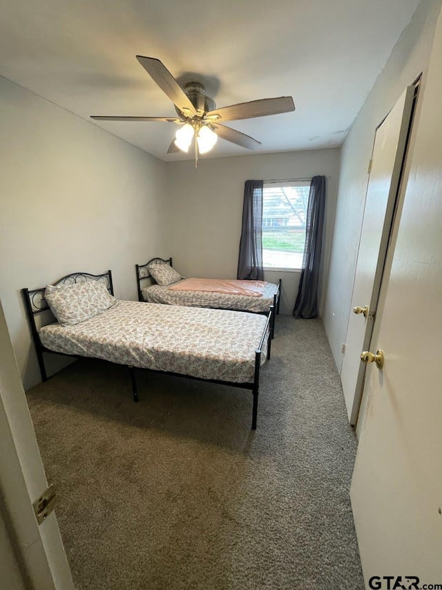 bedroom with a ceiling fan and carpet floors