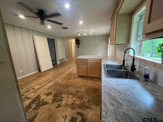 kitchen featuring light countertops, visible vents, a peninsula, ceiling fan, and a sink