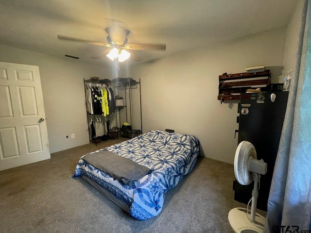 bedroom featuring a ceiling fan, visible vents, and carpet
