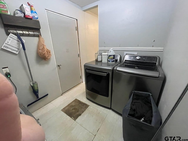 laundry area featuring washing machine and clothes dryer and laundry area