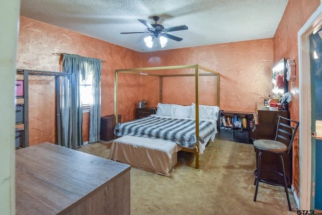 carpeted bedroom featuring ceiling fan and a textured ceiling