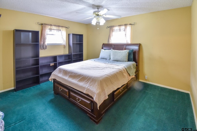 bedroom featuring a textured ceiling, multiple windows, ceiling fan, and dark carpet