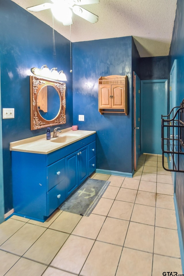 bathroom featuring vanity, a textured ceiling, tile patterned floors, and ceiling fan