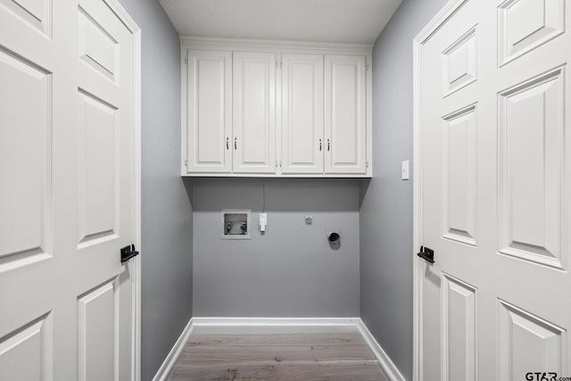 2513 Memory Ln, Tyler, TX 75701 - laundry room featuring cabinet space, washer hookup, wood finished floors, and electric dryer hookup