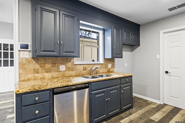 2513 Memory Ln, Tyler, TX 75701 - kitchen with stainless steel dishwasher, decorative backsplash, dark wood-style floors, light stone counters, and blue cabinetry