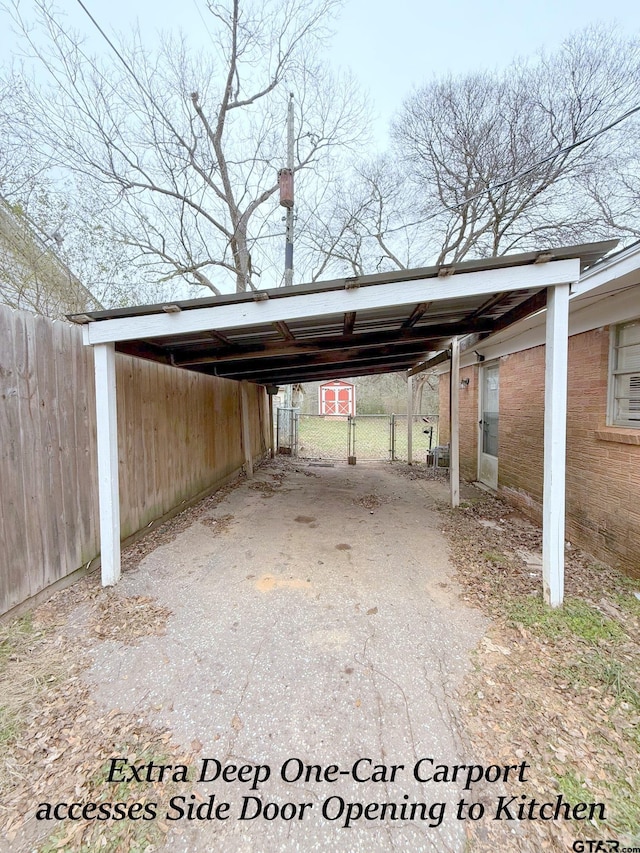 view of parking featuring a carport and fence