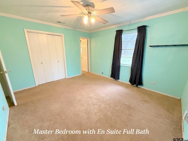 unfurnished bedroom featuring light carpet, a ceiling fan, visible vents, a closet, and crown molding