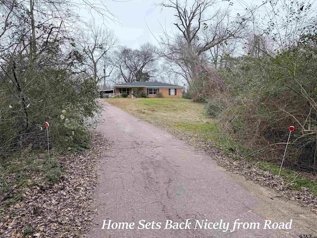 view of street featuring aphalt driveway