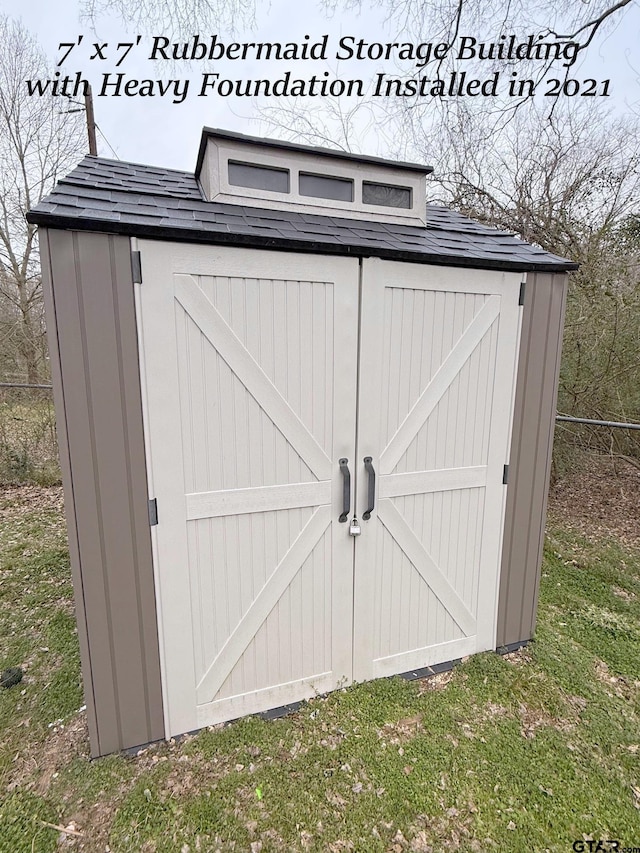 view of shed featuring fence