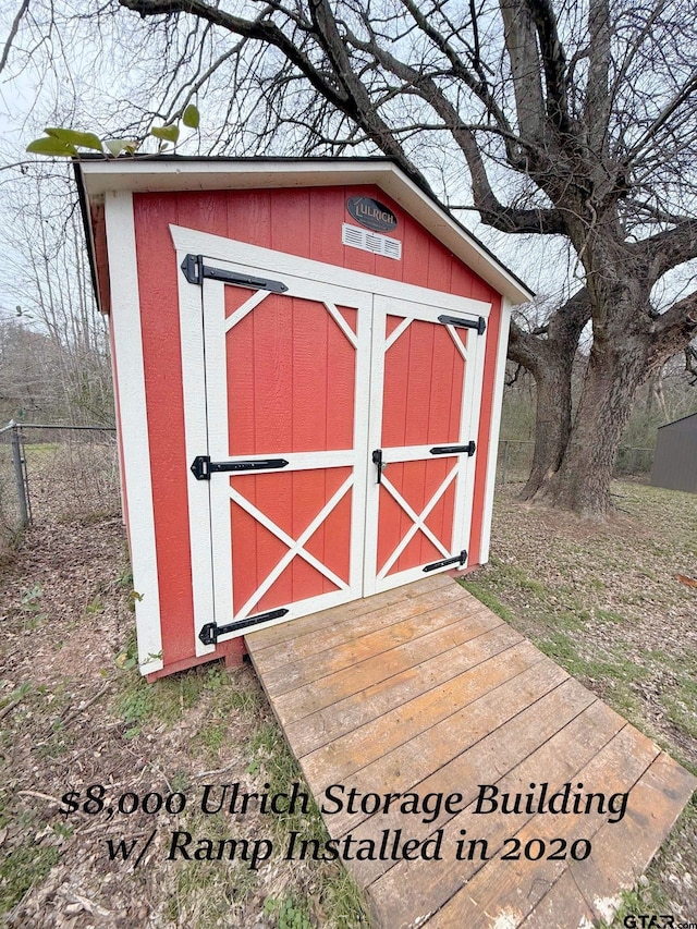 view of shed with fence