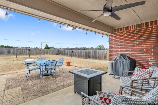 view of patio with ceiling fan and area for grilling