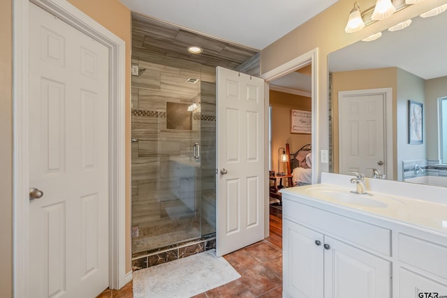 bathroom with an enclosed shower, vanity, and tile patterned floors