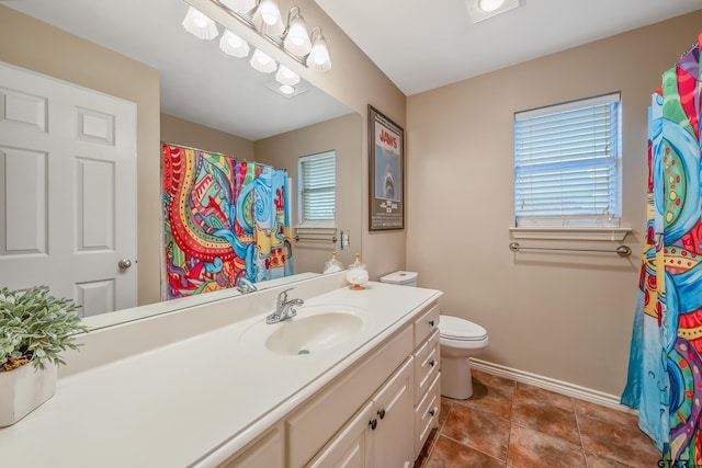 bathroom featuring toilet, vanity, and tile patterned floors