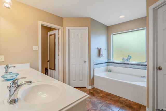 bathroom with vanity and a relaxing tiled tub