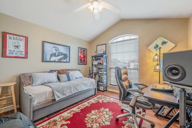 bedroom with ceiling fan, lofted ceiling, hardwood / wood-style flooring, and multiple windows