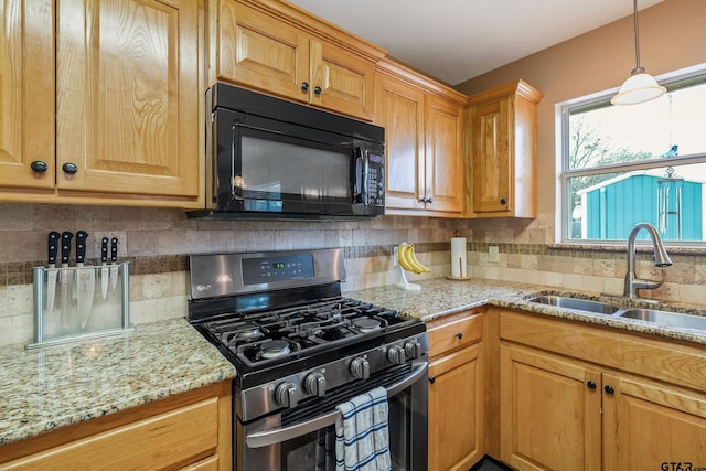 kitchen with tasteful backsplash, sink, stainless steel gas range, and light stone counters