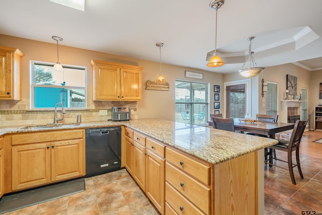 kitchen featuring sink, hanging light fixtures, backsplash, and dishwasher