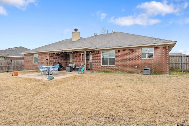 back of property featuring a patio area and a lawn