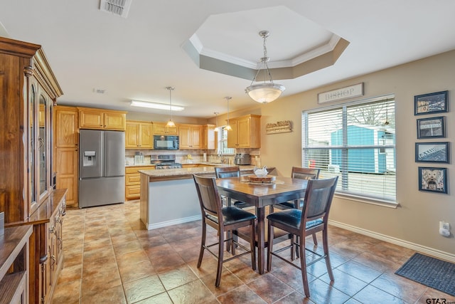 dining space with crown molding, light tile patterned floors, sink, and a tray ceiling