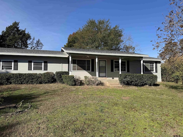 ranch-style home featuring a porch and a front lawn