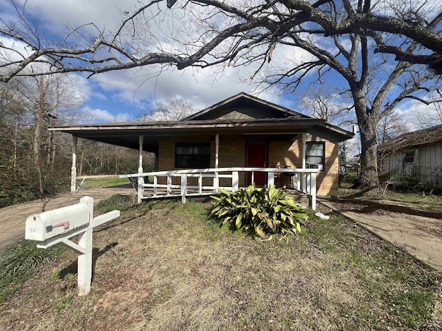 210 Ash St, Crockett, TX 75835 - view of front of house with covered porch and brick siding