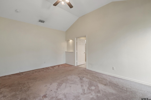 empty room featuring light carpet, baseboards, visible vents, a ceiling fan, and vaulted ceiling