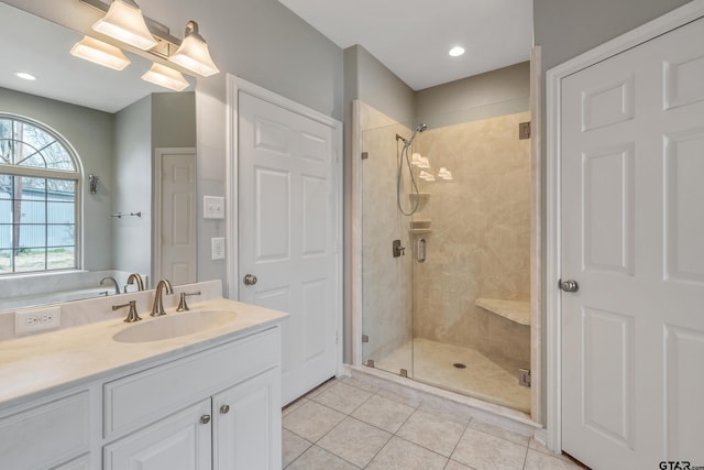 bathroom featuring a stall shower, vanity, and tile patterned floors