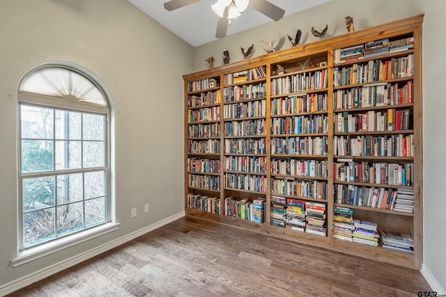 interior space with ceiling fan, baseboards, and wood finished floors