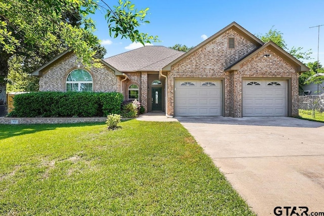 view of front of property featuring concrete driveway, brick siding, an attached garage, a shingled roof, and a front yard