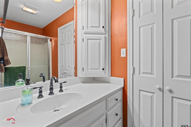 bathroom featuring vanity and a shower with shower door