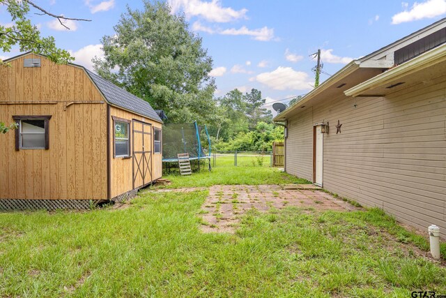 1805 San Saba Dr, Bullard, TX 75757 - view of yard with a trampoline and an outdoor structure