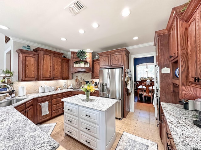 599 N Weldon St, Frankston, TX 75763 - kitchen with appliances with stainless steel finishes, a sink, decorative backsplash, ornamental molding, and recessed lighting