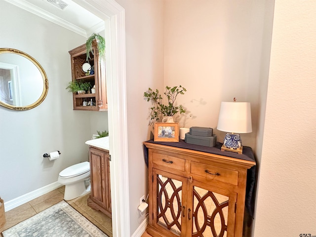 599 N Weldon St, Frankston, TX 75763 - bathroom with toilet, vanity, ornamental molding, tile patterned flooring, and baseboards