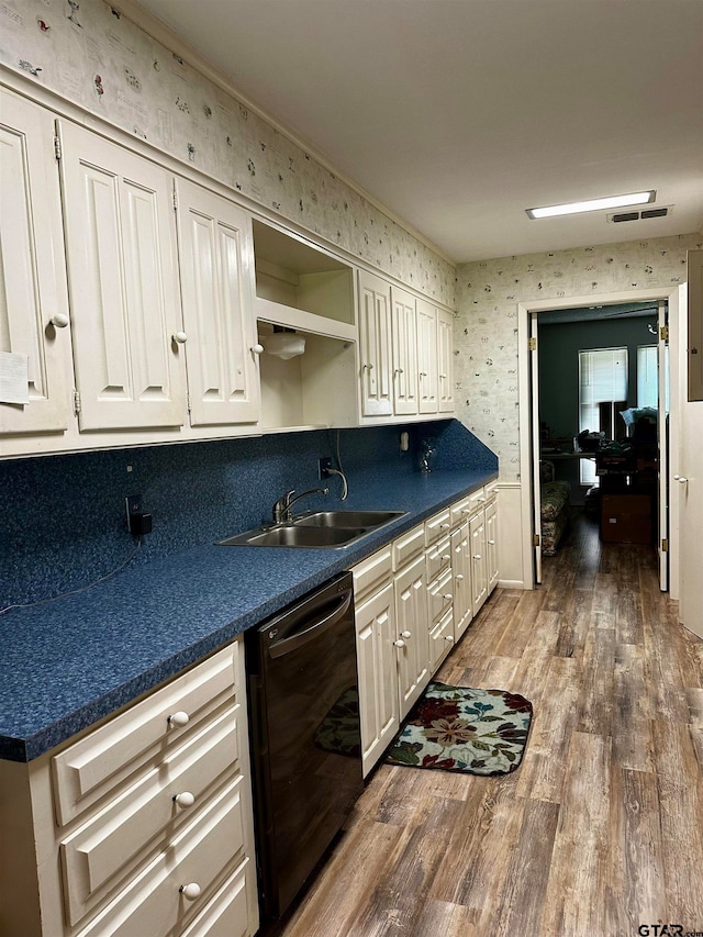 kitchen with dishwasher, white cabinetry, sink, and dark hardwood / wood-style floors